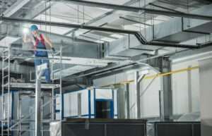 Professional Hvac Technician With Flashlight Overlooking Finishe